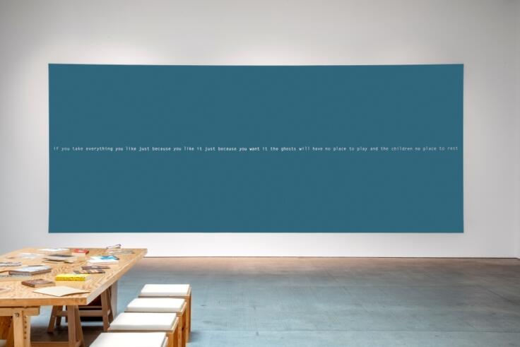Blue and white canvas on wall. Stencil, paint, 9m x 3m. Large-scale site-specific wall text work created as part of I Will Keep My Soul, with the text written for the book. Presented at Art + Practice (Los Angeles, 2023).