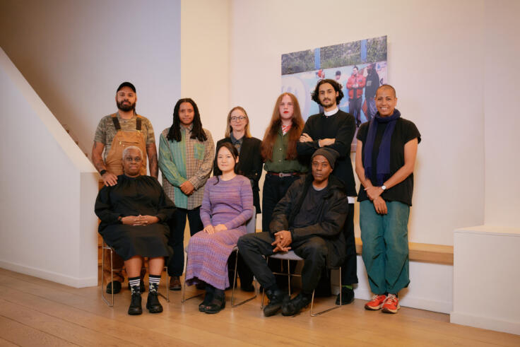 Group photograph of Awards for Artists 2023 recipients. Back row L-R: Marcus Macdonald on behalf of Black Obsidian Sound System (B.O.S.S.), Nneka Cummins, Pippa Murphy, Jamie Crewe, Imran Perretta, Helen Cammock. Front L-R: Ain Bailey, Hyelim Kim, Edward George. Not pictured: Francesca Pidgeon (Dilettante), Karine Polwart (part of composing duo with Pippa Murphy), eight other members of Black Obsidian Sound System