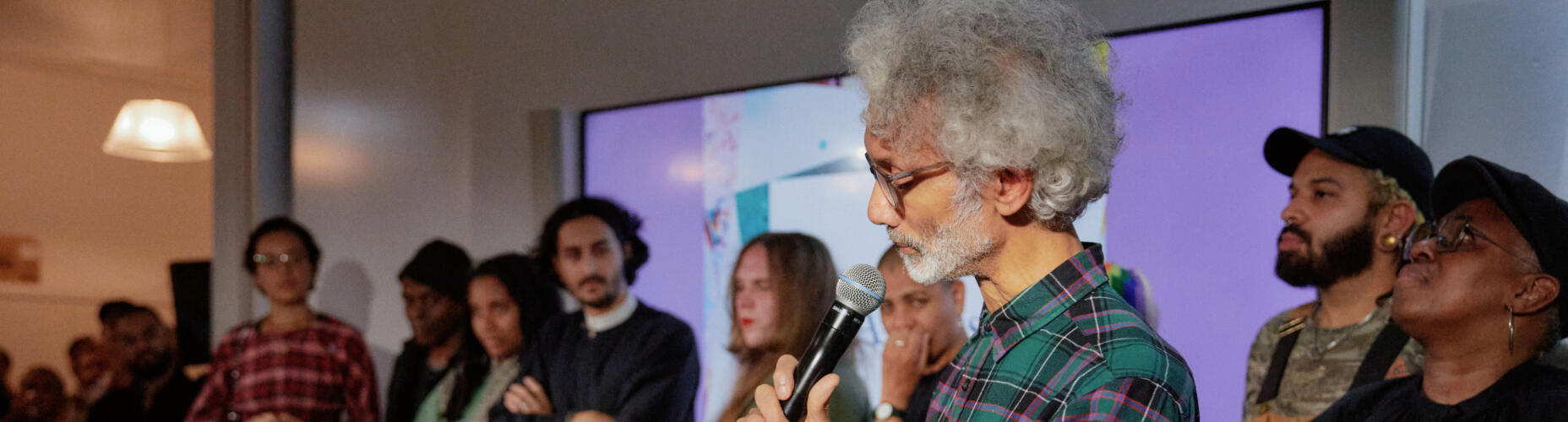 Kevin Le Gendre (Chair of Composers judging panel) speaks about the recipients of Awards for Artists 2023 who've joined him on stage. Photo credit: Emile Holba