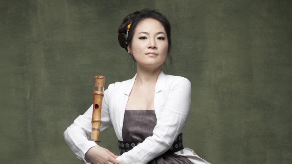 Hyelim Kim stands with daegeum - a traditional Korean musical instrument.