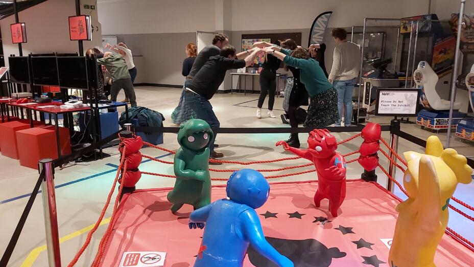 Teachers take part in an active CPD session at a boxing ring - you can see bright blue, red, yellow plastic figures in a red boxing ring.