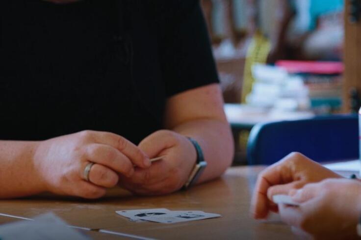 Teachers take part in reflective session which involves playing a game like snap. Photo: brettinthecity.