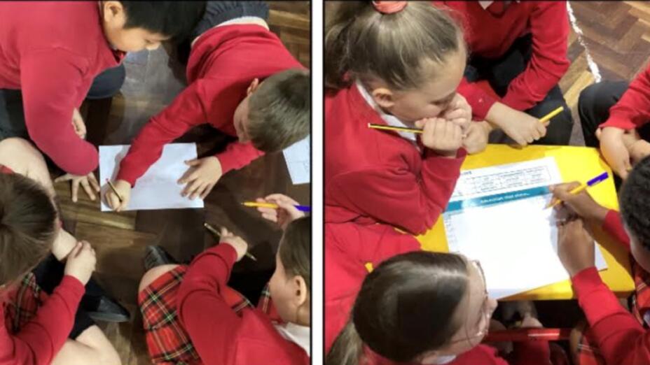 Groups of pupils in red uniforms actively engage in an English lesson that takes a drama-based approach.