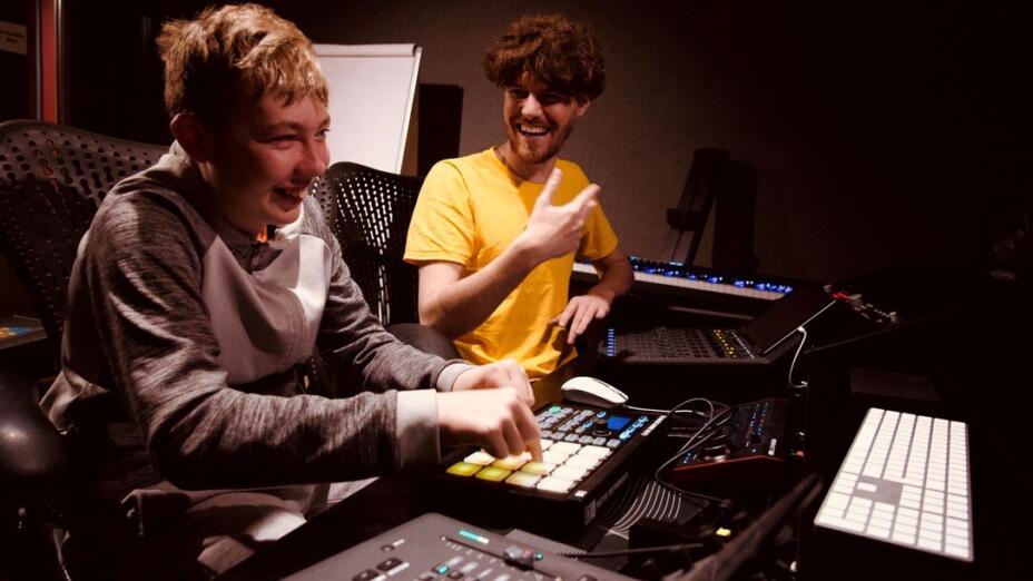 Young person and music leader making music at a recording studio at The Music Works.