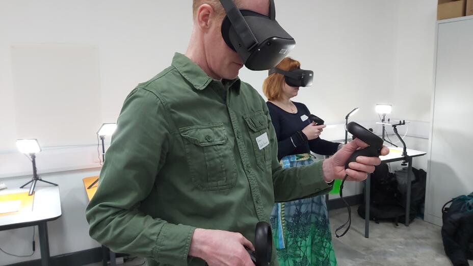Two teachers take part in a CPD session as part of the WorldBuilders programme. They both wear VR headsets in a white room.
